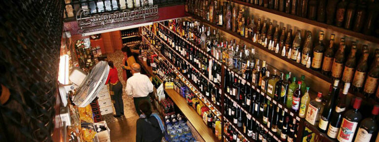 Interior of La Pubilla del Taulat, a traditional wine bar with shelves of wines and spirits in Poblenou
