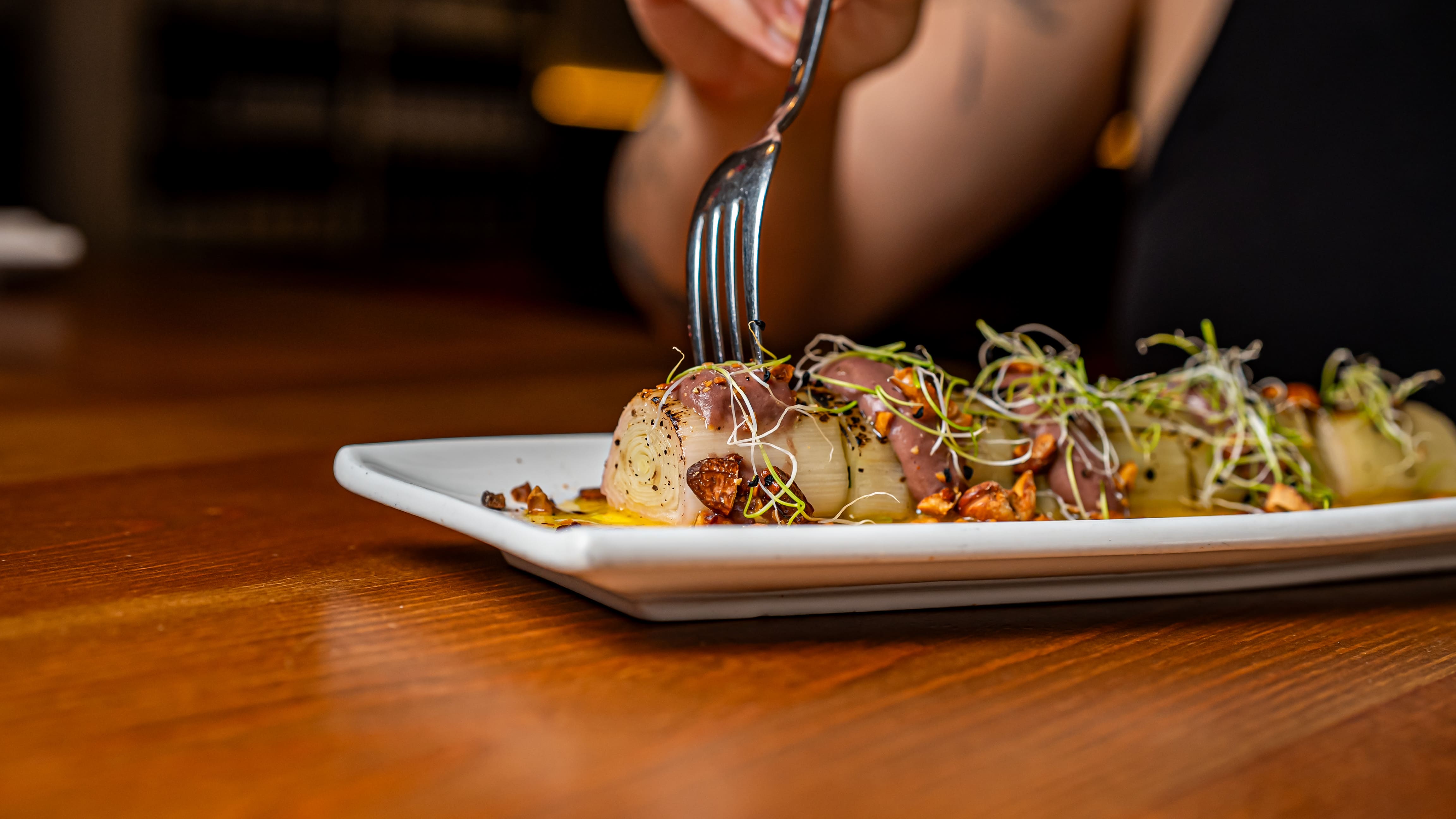 Confit leeks with romesco, textured fresh cheese and sprouts at Més de Vi